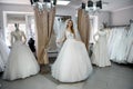 Young woman in wedding dress and veil in bridal shop Royalty Free Stock Photo