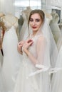 Young woman in wedding dress and veil in bridal shop Royalty Free Stock Photo