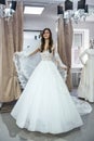 Young woman in wedding dress and veil in bridal shop Royalty Free Stock Photo