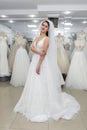 Young woman in wedding dress and veil in bridal shop Royalty Free Stock Photo