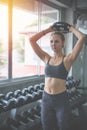 Young woman weightlifter lifting bench press working out with dumbbell in the gym Royalty Free Stock Photo