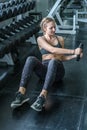 Young woman weightlifter lifting bench press working out with dumbbell in the gym