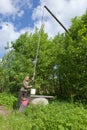 The young woman at a well,pours water in a bucket