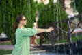 Young woman wets his hands in the fountain Royalty Free Stock Photo