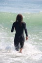 Young Woman in a Wetsuit at Beach Royalty Free Stock Photo