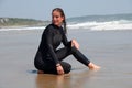 Young Woman in a Wetsuit at Beach Royalty Free Stock Photo