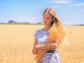 Young woman at the wheat field under the blue sky at the sunny day Royalty Free Stock Photo