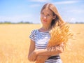 Young woman at the wheat field under the blue sky at the sunny day Royalty Free Stock Photo