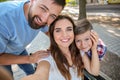 Young woman in wheelchair with her family taking selfie outdoors Royalty Free Stock Photo