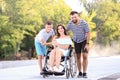 Young woman in wheelchair with her family walking outdoors Royalty Free Stock Photo