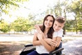 Young woman in wheelchair with her son walking outdoors Royalty Free Stock Photo