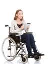 Young woman in wheelchair holding a tablet