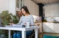 Woman in wheelchair reading documents at her desk at home Royalty Free Stock Photo