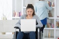 Young woman on wheelchair using laptop Royalty Free Stock Photo