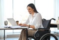 Young woman in wheelchair using laptop Royalty Free Stock Photo