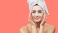 Young woman with white bath towel in her hair and mouisturizing face mask. Wellness and Spa concept. Royalty Free Stock Photo