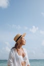 Young woman in a white bathing suit and hat sunbathing on the beach Royalty Free Stock Photo