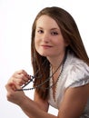 Young woman in white blouse holding bead necklace