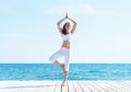 Young woman in white clothes on a pear Royalty Free Stock Photo