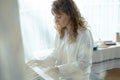 Young woman in white clothes sitting and playing an electronic piano Royalty Free Stock Photo