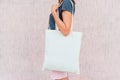 Young woman with white cotton bag in her hands. Royalty Free Stock Photo