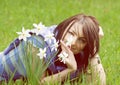 Young woman with white daffodils, yellow filter Royalty Free Stock Photo