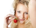 Young woman in white dress eating strawberries Royalty Free Stock Photo