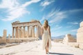 Young woman in white dress on the ruins of the Acropolis of Athens, Greece, Female tourist standing in front of the Parthenon,