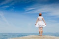 Young woman in white dress sunbathing at the seaside Royalty Free Stock Photo