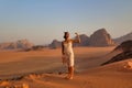 young woman in white dress at sunset in wadi rum desert Royalty Free Stock Photo