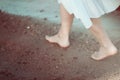 Young woman in white dress walking alone on the beach Royalty Free Stock Photo