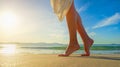 Young woman in white dress walking alone on the beach in the sun Royalty Free Stock Photo