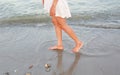 Young woman in white dress walking alone on the beach Royalty Free Stock Photo