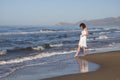 Young woman in white dress walking near a beach in hot sunny summer day Royalty Free Stock Photo