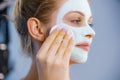 Girl removes dry white mud mask Royalty Free Stock Photo