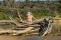 A young woman with a white hat is sitting on a sand beach, Rab Island Royalty Free Stock Photo