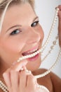 Young woman with white healthy teeth and pearls Royalty Free Stock Photo
