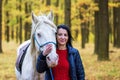 A pretty young woman and a white horse they have a beautiful portrait together Royalty Free Stock Photo