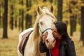 A pretty young woman and a white horse kiss for love Royalty Free Stock Photo