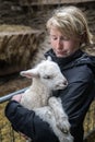 Young woman and a white lambkin