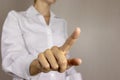 Young woman in white shirt pointing, pushing virtual button with her finger. Business concept Royalty Free Stock Photo