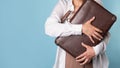 young woman in a white shirt stands grabbing her luggage. A traveler Royalty Free Stock Photo