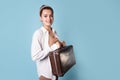 young woman in a white shirt stands grabbing her luggage. A traveler Royalty Free Stock Photo