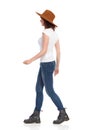Young Woman In White T-Shirt And Hat Is Walking And Looking Away Royalty Free Stock Photo
