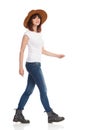 Young Woman In White T-Shirt And Hat Is Walking And Looking At Camera Royalty Free Stock Photo