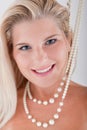 Young woman with white teeth and pearls Royalty Free Stock Photo