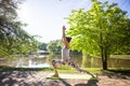 Young woman in white top practicing yoga in beautiful nature. Meditation in morning sunny day Royalty Free Stock Photo