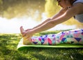 Young woman in white top practicing yoga in beautiful nature. Meditation in morning sunny day