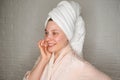 Young woman in white towel chilling and making facial mask. Royalty Free Stock Photo