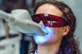 Young woman whiten teeth at the dentist. Close up view